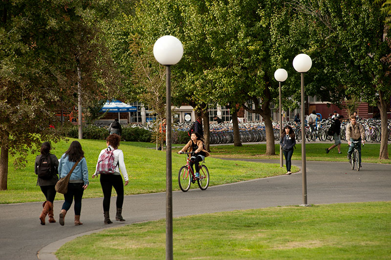 students walking and biking on campus